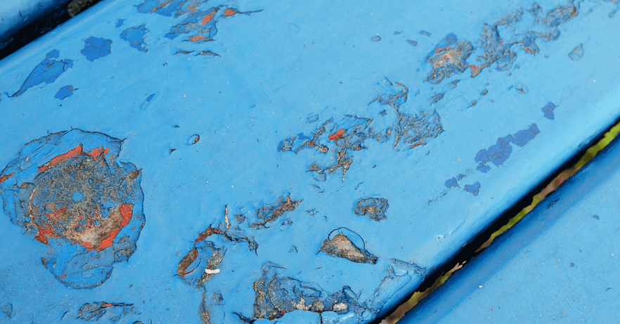 closeup-shot-blue-metal-table-with-chipped-paint-showing-old-layer 1